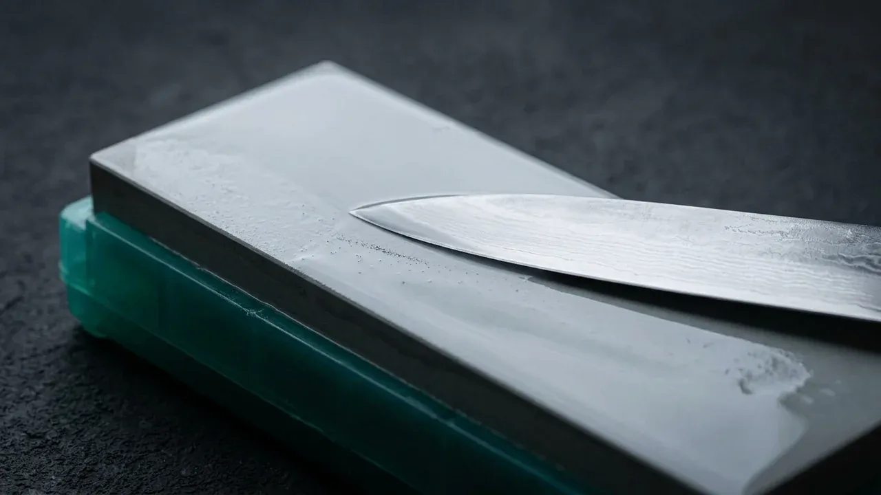 Cuchillo japonés puliéndose sobre la piedra Shapton 8000 mojada, el paso final de acabado del filo